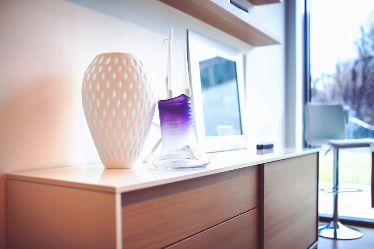 services-05 A stylish modern interior featuring decorative vases on a wooden sideboard, exuding contemporary design.
